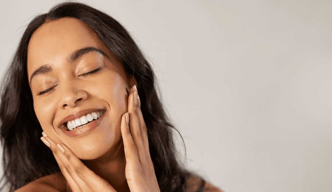 Woman with glowing, healthy skin, showcasing the benefits of professional skincare products in Orange, CA.